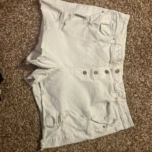 Distressed white jean shorts
